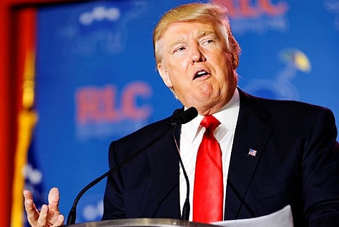 Image of Donald Trump giving speech. behind him is a dark blue background.