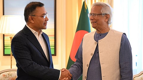 Tarique Rahman and Dr. Yunus meeting in London. Both are shaking hands and the Bangladesh flag can be seen in the background.