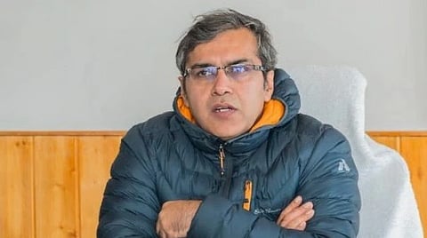 Sanjeev Khirwar wearing a blue jacket, wearing spectatles, hands folded