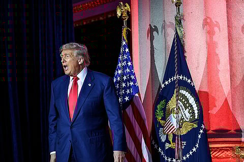 President Donald Trump arrives to the White House AI Summit at Andrew W. Mellon Auditorium in Washington, D.C., Wednesday, July 23, 2025. He is wearing a blue suit, the US flag is behind him.