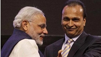 Narendra Modi and Anil Ambani standing together, both smiling.