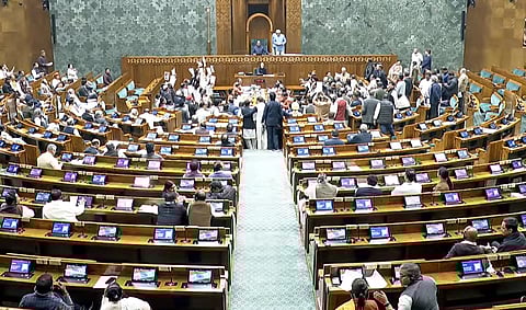 Opposition MPs protest in the well of the Lok Sabha.