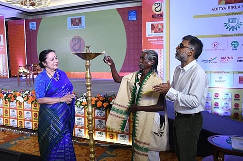 In the image Haldhar Nag is shown with two other people in an event