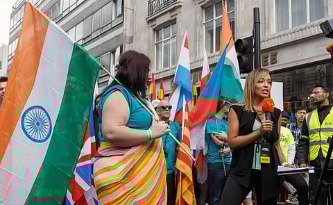 Image of A reporter from local television station London Live interviews the flag bearer for India before the parade at Pride in London 2016.