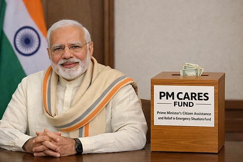 In the image PM Modi is shown and alongside him is the LOGO of PM CARES Funds and behind it a singh of rupee