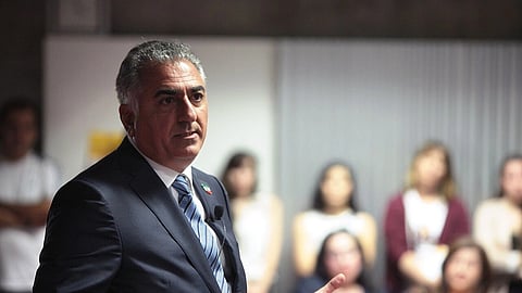 In the image Prince Reza Pahlavi is shown speaking to the audience