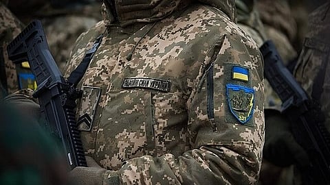 In the image Ukraine soldier is shown in his uniform and batch only uniform and batch is visible