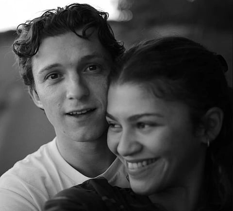 Black and white photo of actors Zendaya and Tom Holland.
