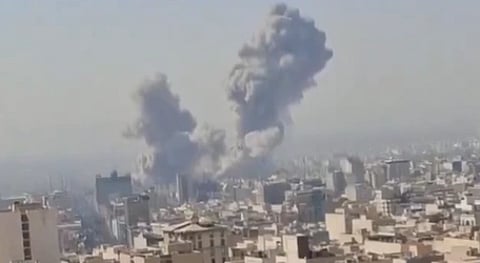 Image of a plume of smoke emerging after an attack on a city. the image is of low resolution.