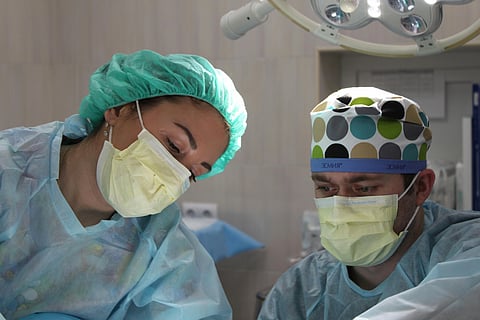 In the image two doctors are shown treating a patient