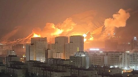 In the image Iran is shown with buildings burning with red flames