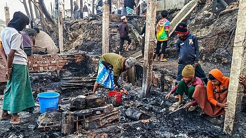 In the image fired building blocks are shown with children and adults sitting there