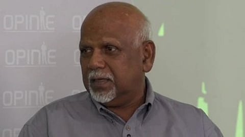 A man is shown looking at his side the background look like a projector screen