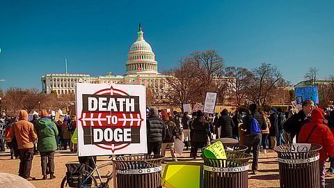 "Death to DOGE" sign with people in the background at a No Kings Day Protest, Washington, DC USA.