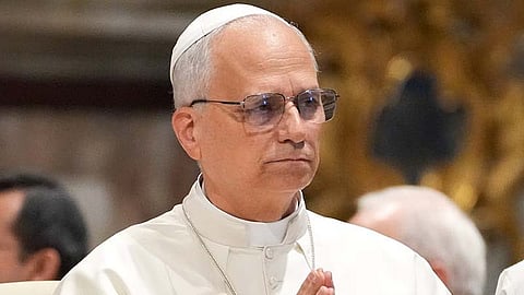 In the image Pope Leo is shown with glasses joining his hands