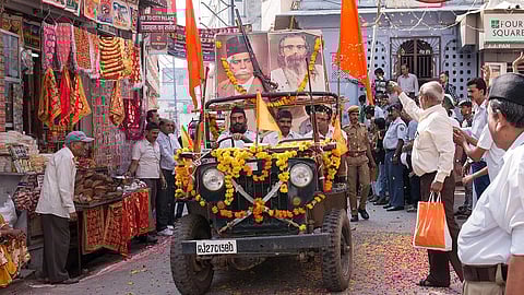 RSS pracharaks in a jeep garlanded with flowers and flags carrying portraits of KB Hedgewar and MS Golwalkar through a street in Udaipur