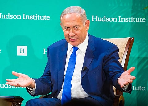 Image of Benjamin Netanyahu Receives Hudson's Herman Kahn Award. he is wearing his dark blue suit and his gesturing something.