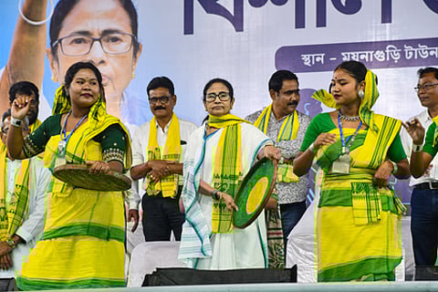 Jalpaiguri: West Bengal Chief Minister Mamata Banerjee joins local artists in a cultural performance during a public meeting as part of her election campaign ahead of the West Bengal Assembly elections, in Maynaguri, Jalpaiguri district of West Bengal, Wednesday, March 25, 2026. (Photo: IANS)