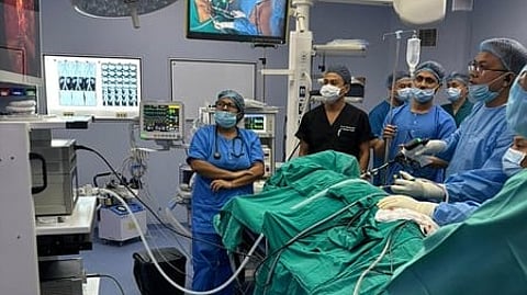 Hospital scene is shown doctors are looking at a monitor