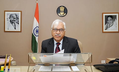 The image showcases SY Quraishi, the former Chief Election Commissioner of India, sitting at a desk