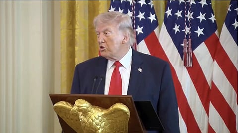 In the image United States is shown standing in a podium adressing the people