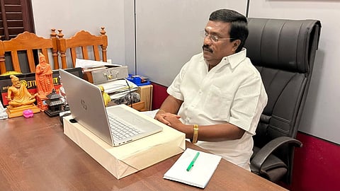 Puducherry Assembly Elections 2026: R Siva working at a laptop, sitting at a desk in his office
