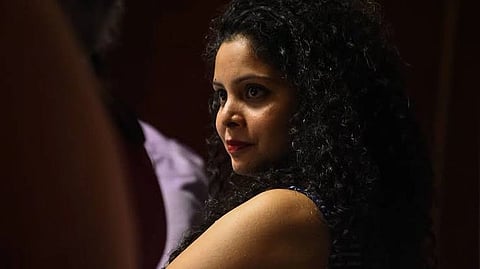 In the image Rana Ayyub is shown