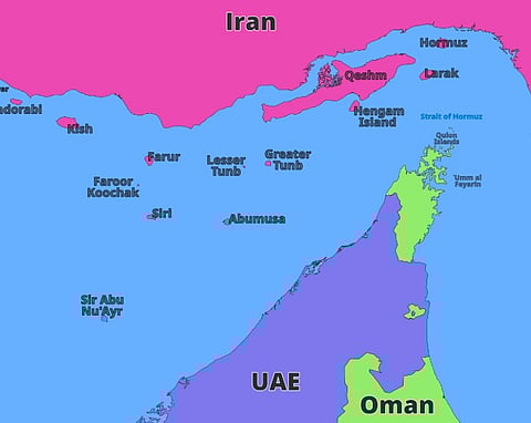 Map showing the Strait of Hormuz area with Iran in pink, UAE in purple, and Oman in green. Key islands like Qeshm and Abu Musa are marked.