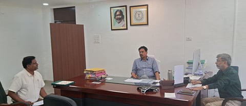 In the image three officers are shown in a office