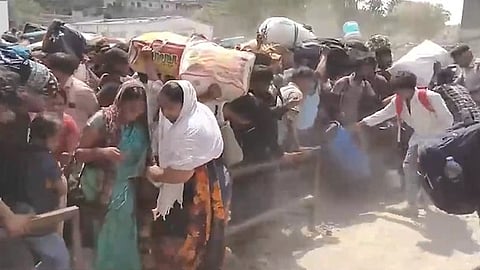 A large crowd of people with lots of luggage