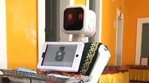 A robot is shown welcoming people