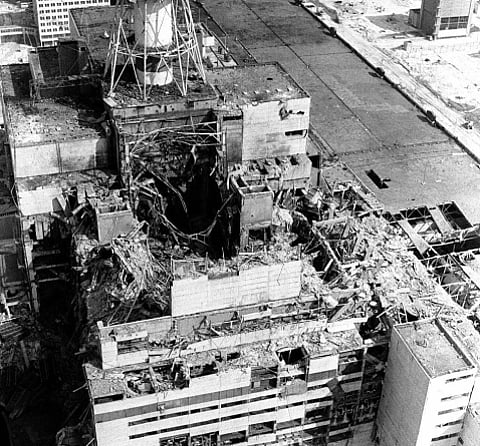 Aftermath of the 1986 Chernobyl Nuclear Power Plant disaster, Ukraine in the former USSR
Aerial view of a destroyed industrial building with a large, gaping hole in the center. Debris is scattered, conveying destruction and chaos.
