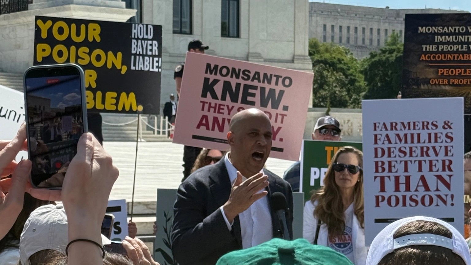 In the image protesters are shown outside US Supreme Court with different placards