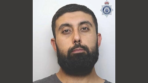 In the image the criminal Asad Hussain is shown looking at the camera