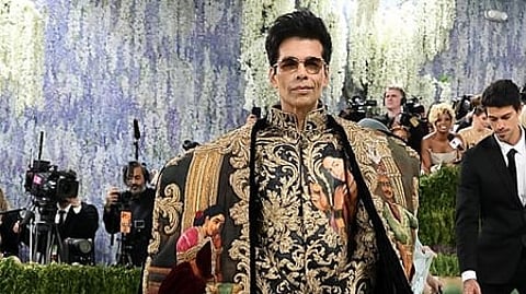 In the image Karan Johar is shown with his outfit covered in raja ravi verma paintings in Met gala