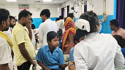 People and children in a hospital ward