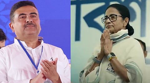 Image of Suvendu Adhikari and Mamata banerjee stand side by side, each with hands folded in a gesture of respect. Both wear glasses and white attire, against a blue backdrop.