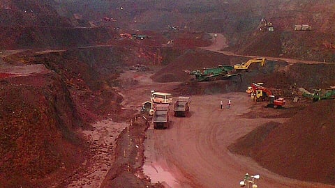 trucks, red sand and water at Indarini Patnaik mine in Odisha