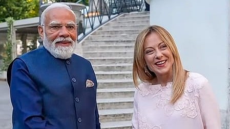 In the image PM Modi and Meloni are shown smiling at the camera