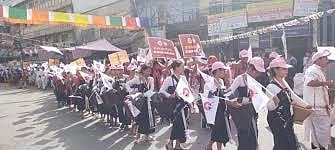 Thousands of tribal protesters marching with flags and traditional attire near Red Fort in Delhi demanding de-listing of converted ST members