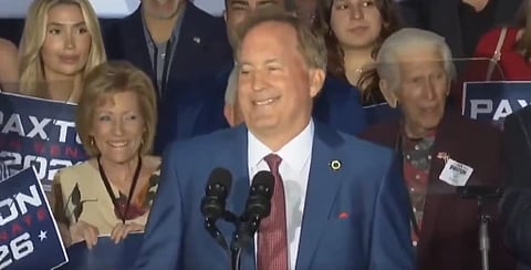 In the image Ken Paxton is shown giving a speach