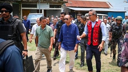 In the image many people are shown with Chief Minister Yumnam Khemchand Singh accompanied by many security personnels walking
