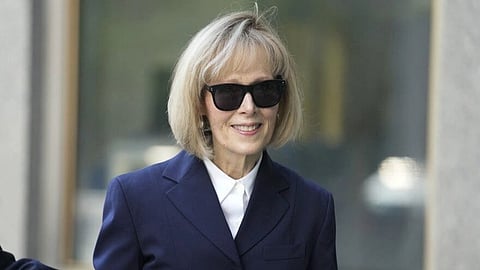 In the image E. Jean Carroll is shown wearing glasses in a formal wear