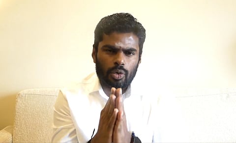 In the image K. Annamalai is shown joining his hands