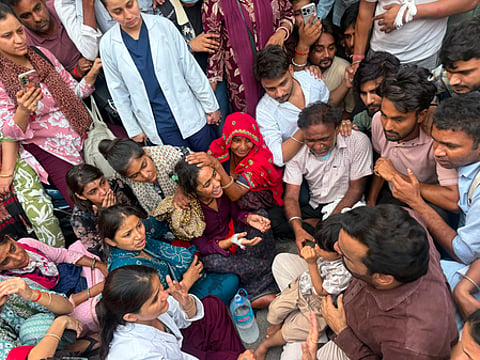 In a group, people are gathered and crying due to the suicide news of the nurse in Rajasthan