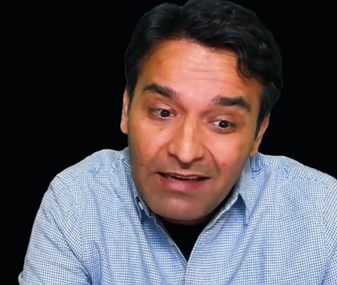 Image of youtuber Amit Kilhor speaking behind him is a black background. the image is a screenshot from one of his videos on X.