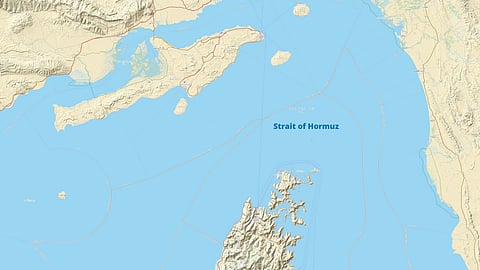 Map highlighting the Strait of Hormuz in light blue, surrounded by detailed landmasses with rugged coastlines, illustrating geographical proximity.