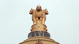India's state emblem of Lion Capital of Ashoka mounted on top of a building.