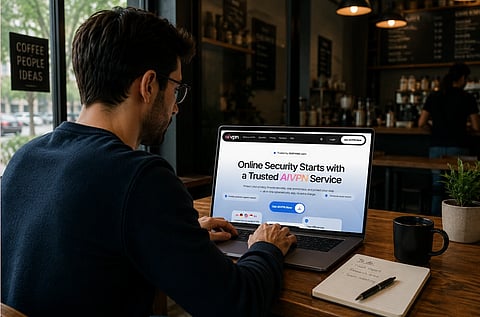 Image of a man sitting in a cafe with a laptop in front of him. he is looking at a screen with the text online security starts with a trusted AIVPN service.