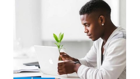 In the image a man is shown with a plant and a apple laptop